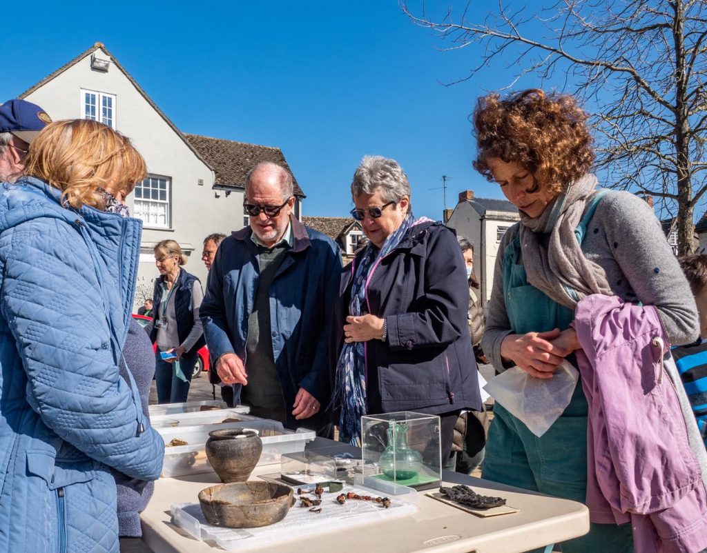 A photo of people looking at ancient artefacts in the Square during Eynsham Heritage Day in March 2022