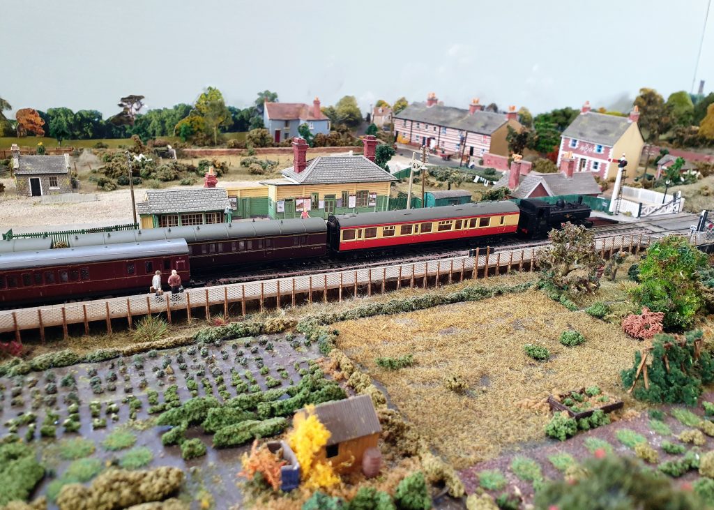 Model of Eynsham Station in the 1950s, created by David Thomas. A passenger train sits at the station with allotments at the front of the photo.