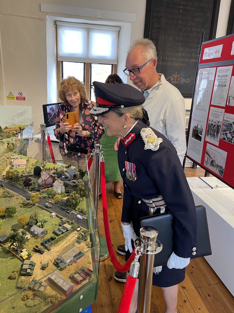 The Lord Lieutenant of Oxon. looking at the working model of Eynsham railway, with Posy Parrinder, and Dave Thomas