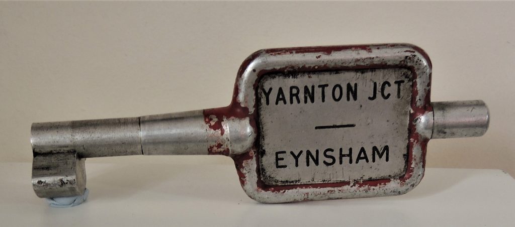 A single railway track key token. It looks a little like a key and is inscribed with the words Yarnton JCT and Eynsham.