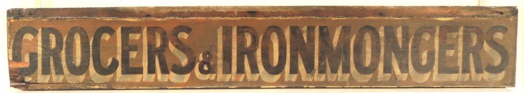Sign from the Sawyers shop, with the words 'Grocers and Ironmongers'